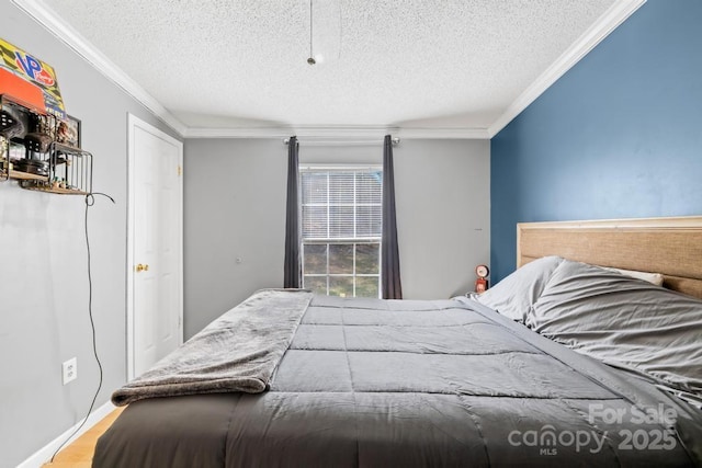 bedroom with ornamental molding and a textured ceiling