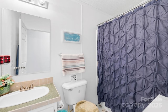 bathroom with toilet, vanity, and a shower with curtain