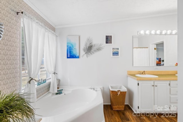 bathroom featuring ornamental molding, hardwood / wood-style flooring, and vanity