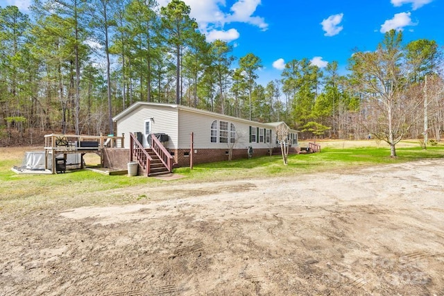 view of front facade with a deck and a front yard