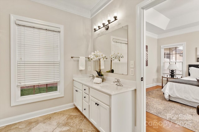 full bathroom featuring baseboards, double vanity, a sink, and crown molding