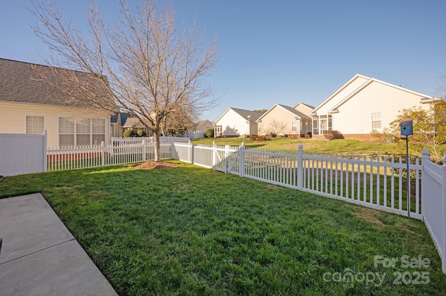 view of yard featuring a residential view and a fenced backyard