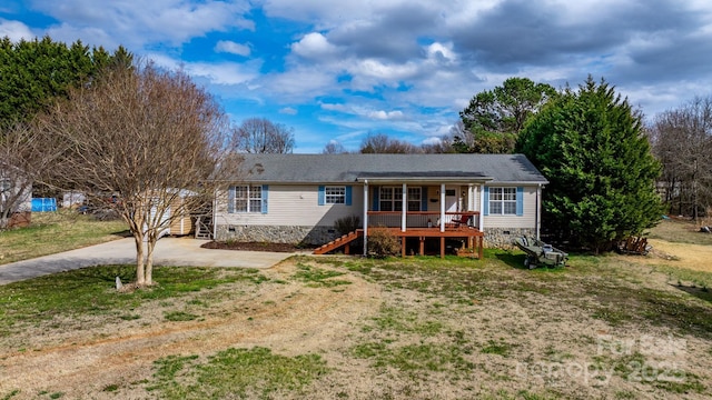 view of front of house with crawl space, stairs, a porch, and a front yard