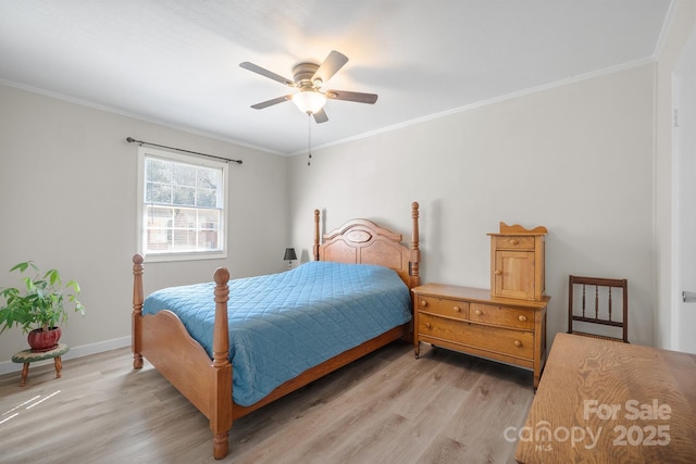 bedroom featuring light wood finished floors, ceiling fan, baseboards, and crown molding