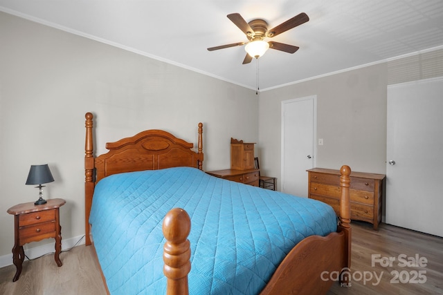 bedroom featuring ornamental molding, ceiling fan, and wood finished floors