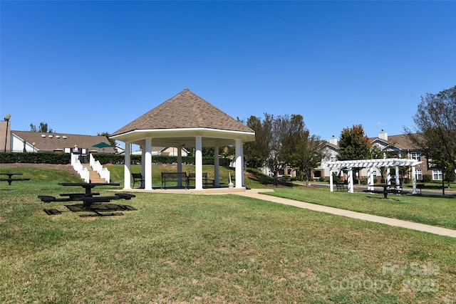 view of property's community featuring a gazebo, a yard, and a pergola