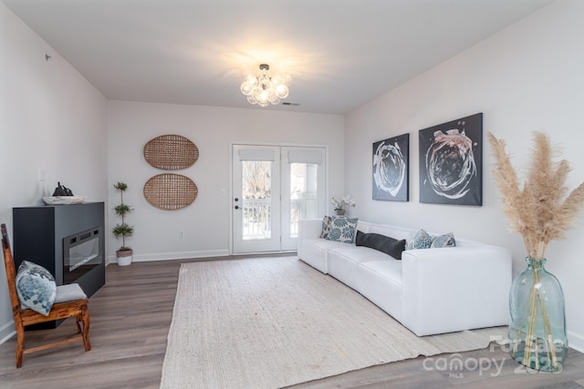 living room featuring hardwood / wood-style floors and a notable chandelier