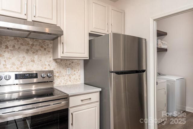 kitchen with stainless steel appliances, tasteful backsplash, separate washer and dryer, and white cabinets