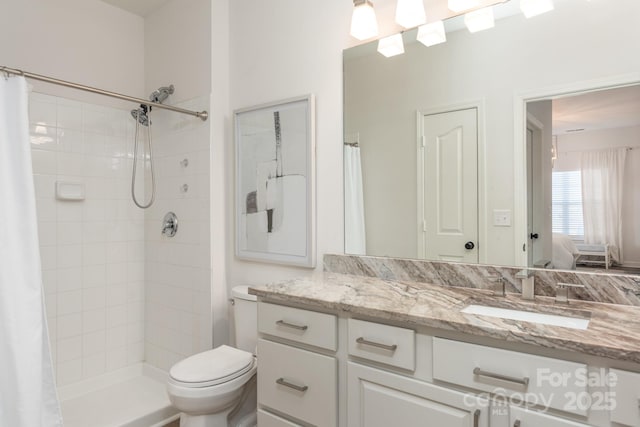 bathroom featuring vanity, toilet, and a shower with curtain