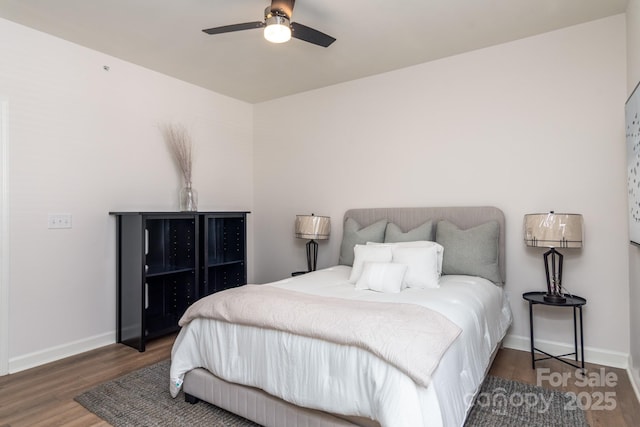 bedroom featuring ceiling fan and dark hardwood / wood-style floors