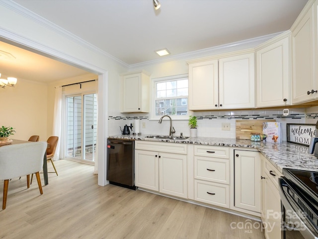 kitchen featuring black dishwasher, light stone counters, a sink, and light wood-style flooring