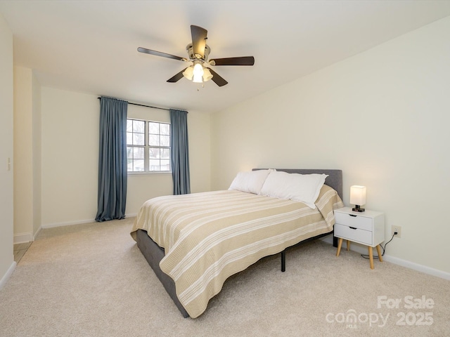 bedroom with ceiling fan, baseboards, and light colored carpet