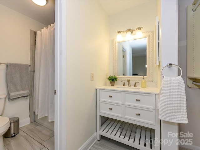 full bath with toilet, baseboards, and vanity