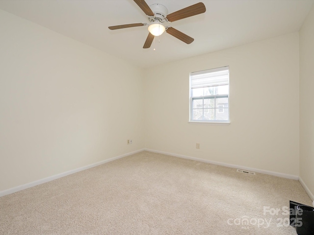 carpeted spare room with baseboards and visible vents