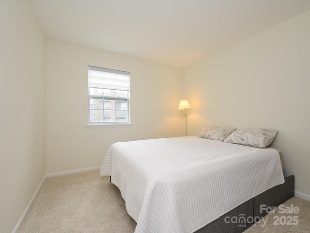 bedroom with carpet floors and baseboards