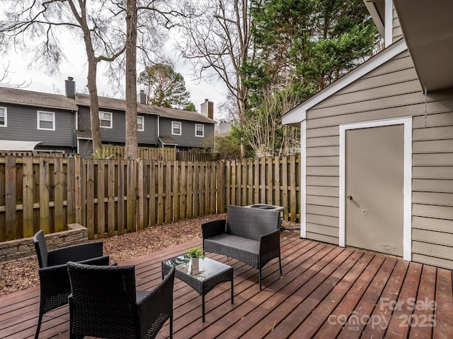 wooden deck featuring a fenced backyard and an outdoor hangout area