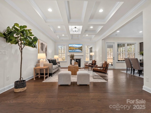 living area featuring dark wood-style flooring, beamed ceiling, plenty of natural light, and a glass covered fireplace