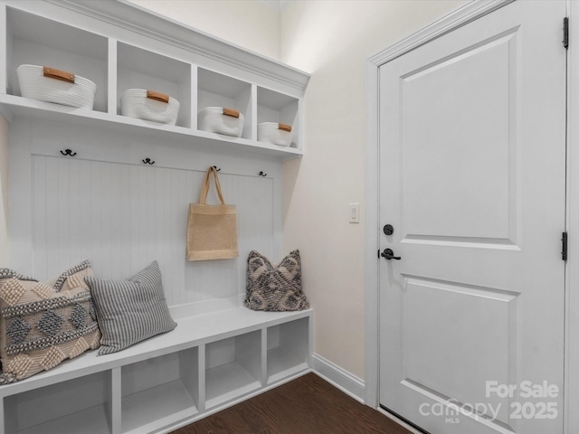 mudroom featuring dark wood-style flooring and baseboards