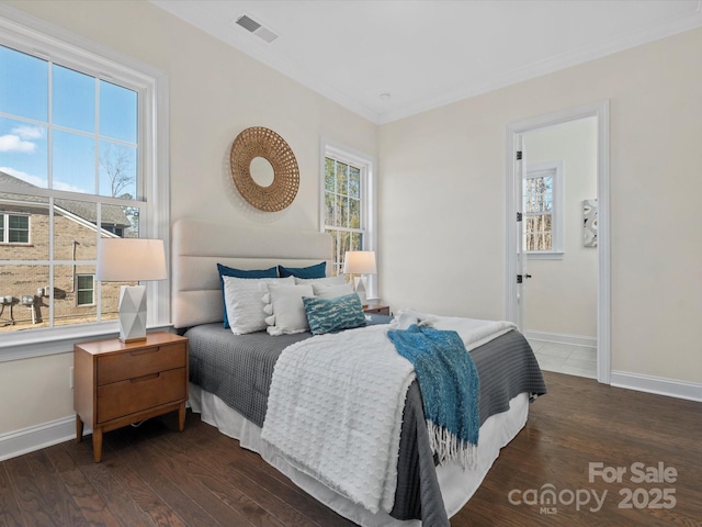 bedroom featuring dark wood-style floors, multiple windows, and baseboards