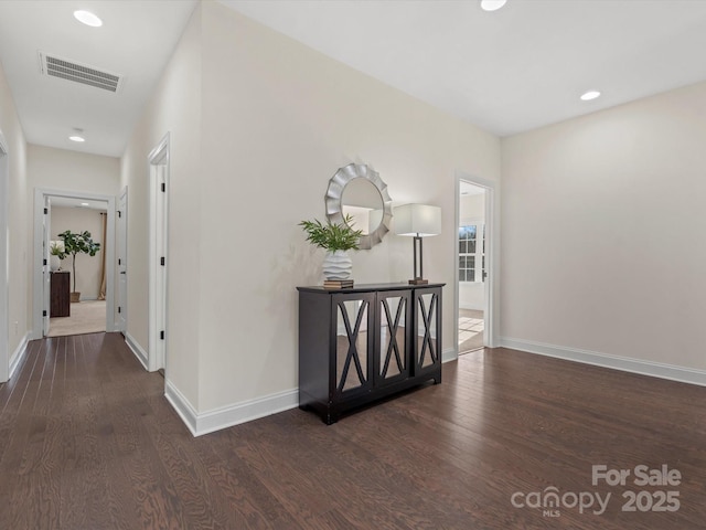 hall featuring recessed lighting, wood finished floors, visible vents, and baseboards