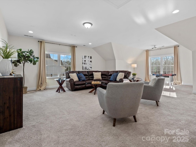 carpeted living area featuring lofted ceiling, visible vents, baseboards, and recessed lighting