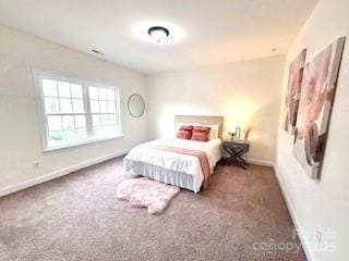 carpeted bedroom featuring baseboards