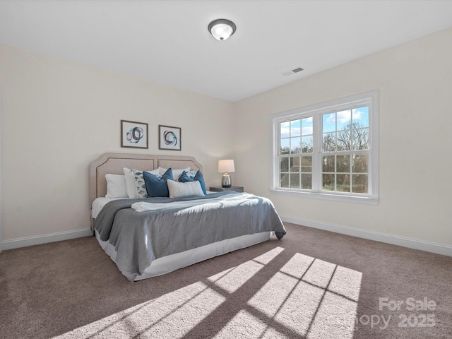 bedroom with carpet flooring, visible vents, and baseboards