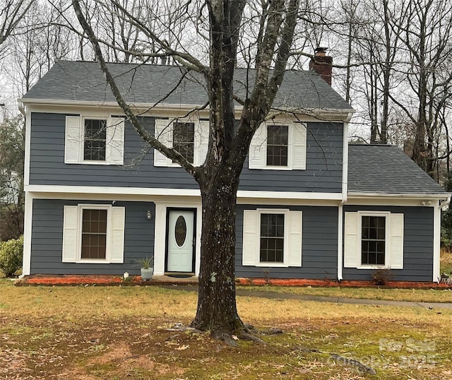 4922 Rivergreen Ln, Charlotte, NC 28227 - view of front of house with a front lawn, a shingled roof, and a chimney