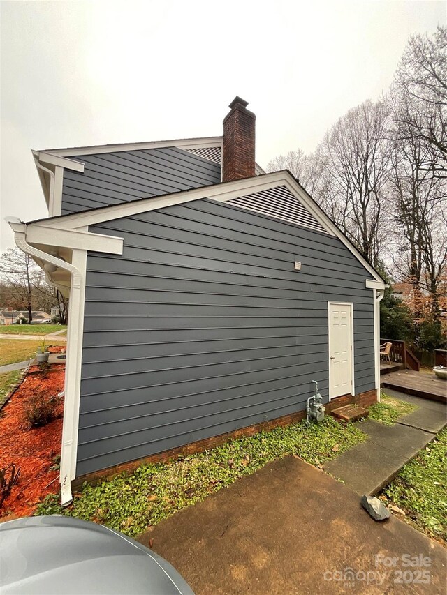 4922 Rivergreen Ln, Charlotte, NC 28227 - view of side of property with a chimney and a deck