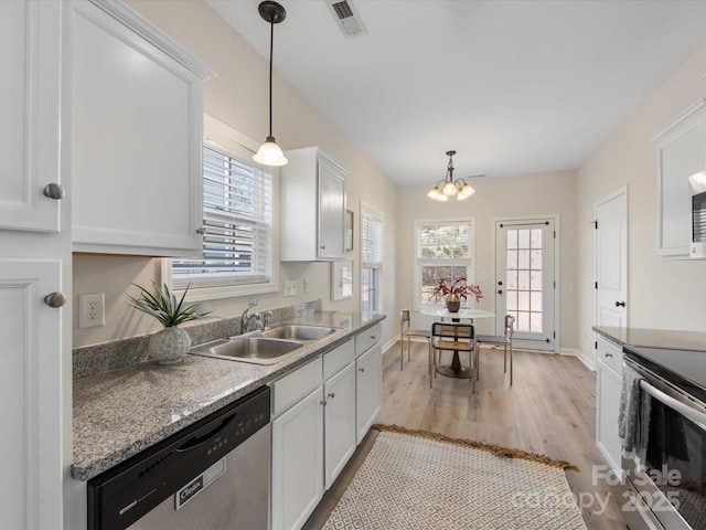 kitchen with light wood-type flooring, stainless steel appliances, decorative light fixtures, sink, and white cabinetry