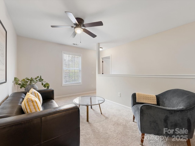 carpeted living room with ceiling fan