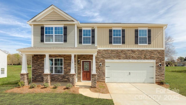 craftsman inspired home featuring a garage and a front yard