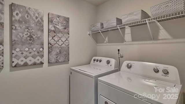 clothes washing area featuring washer and clothes dryer