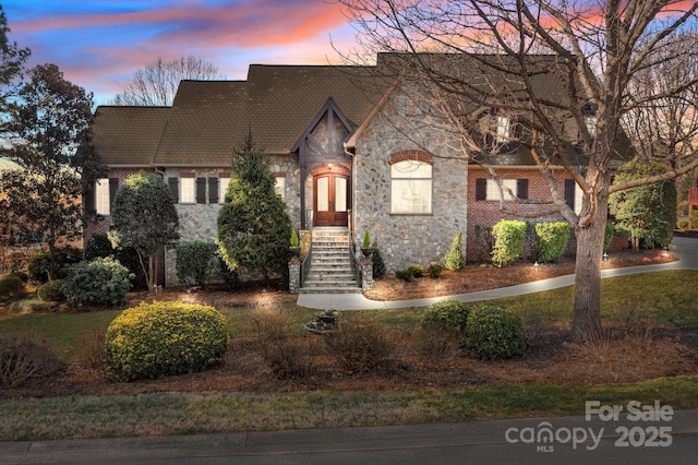 view of front of property with stone siding and brick siding