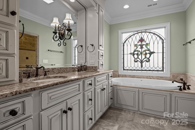 bathroom featuring double vanity, visible vents, a sink, and ornamental molding