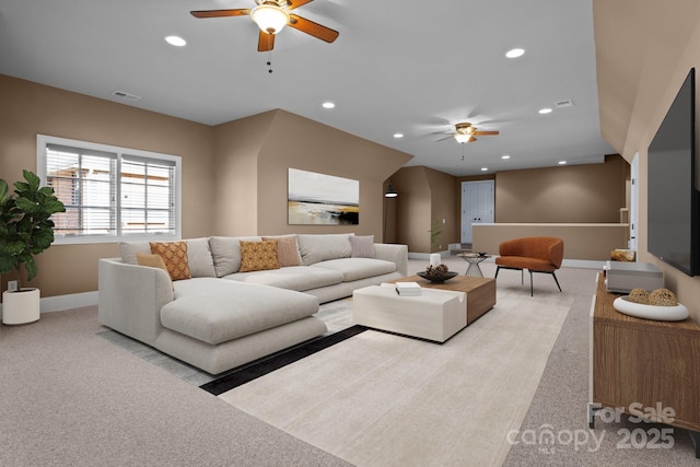 living room with recessed lighting, light colored carpet, and visible vents