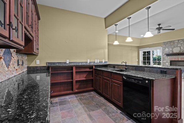 kitchen featuring a peninsula, a sink, hanging light fixtures, dishwasher, and dark stone countertops