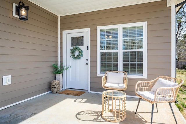 view of exterior entry featuring covered porch