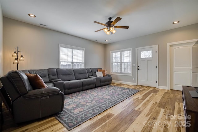 living room featuring ceiling fan and light wood-type flooring