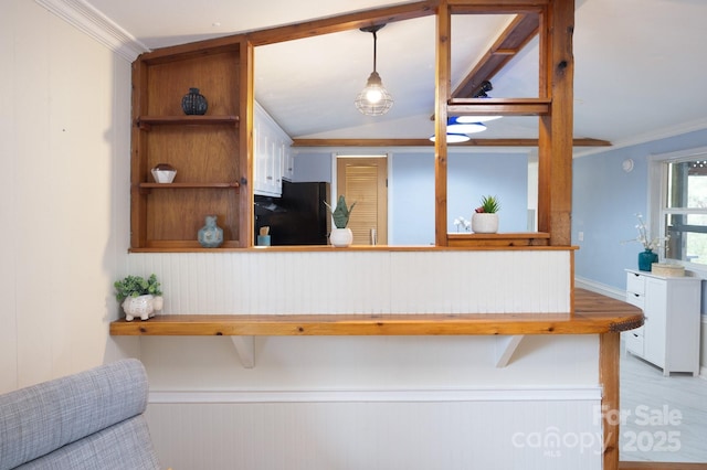 kitchen with vaulted ceiling, ornamental molding, freestanding refrigerator, open shelves, and decorative light fixtures