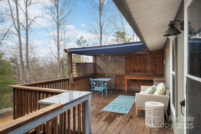 wooden terrace featuring outdoor dining space