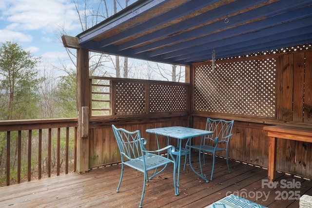 wooden deck featuring outdoor dining area