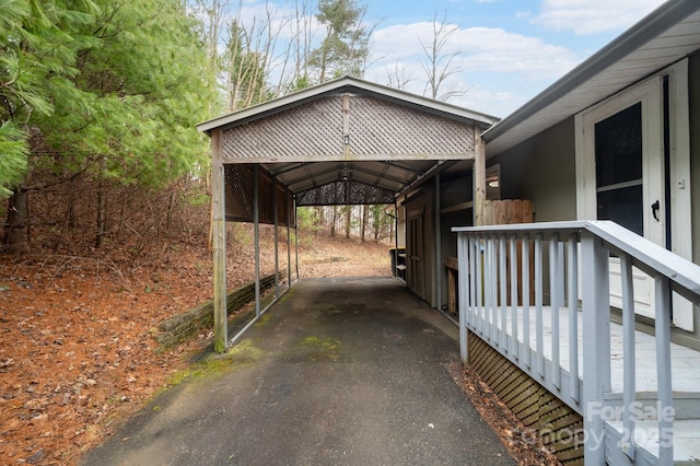 view of parking featuring driveway and a carport