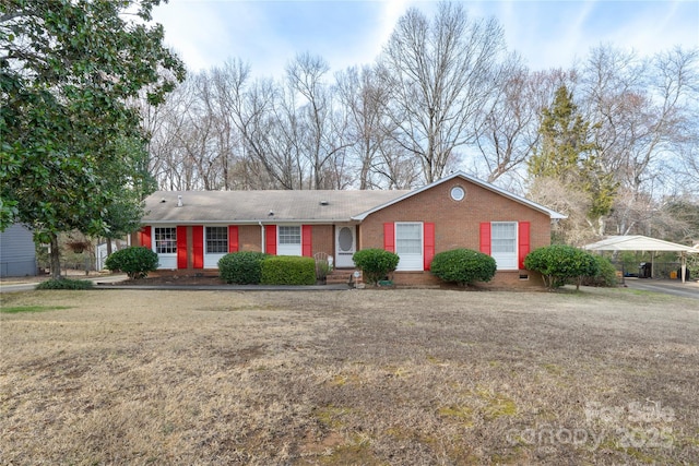 ranch-style house with brick siding and a front lawn