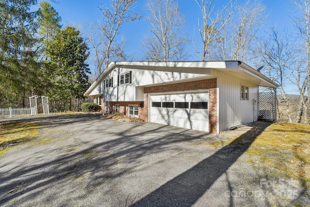 view of side of property with brick siding and driveway