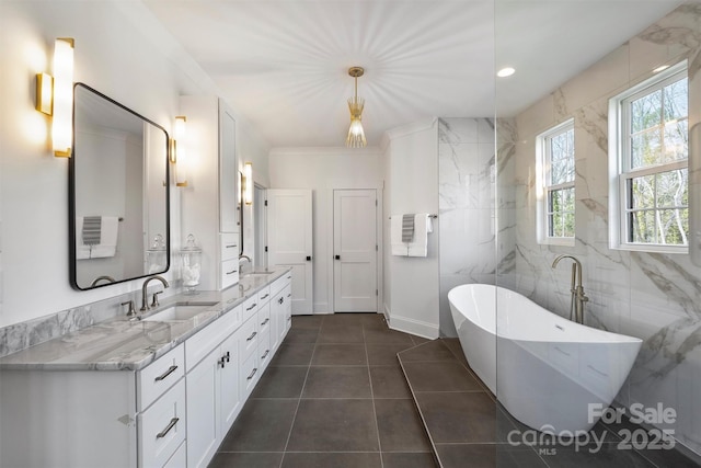 full bathroom with a soaking tub, a sink, tile walls, and double vanity