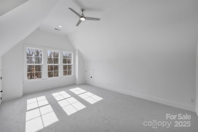 additional living space with carpet, visible vents, vaulted ceiling, and baseboards