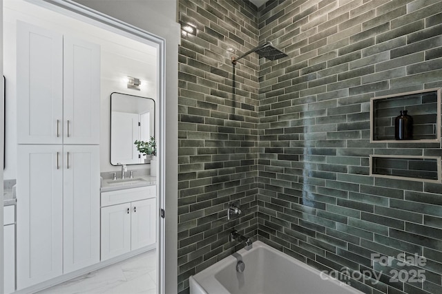 bathroom featuring marble finish floor, vanity, and bathing tub / shower combination