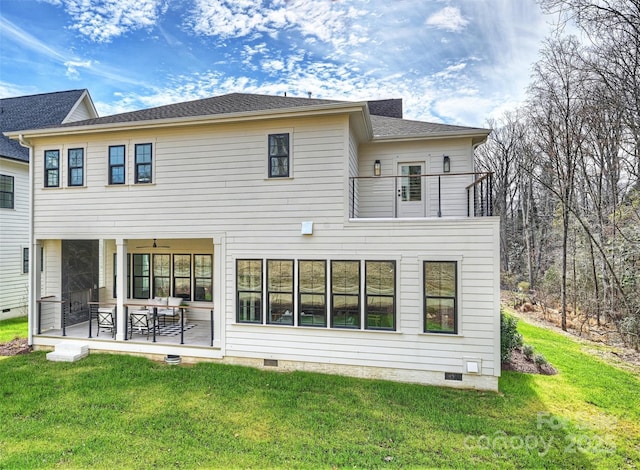 back of house featuring crawl space, a lawn, a balcony, and a patio