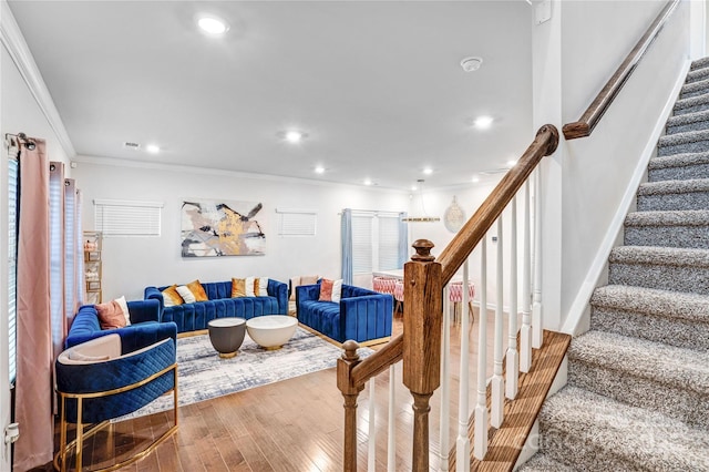 living area featuring stairs, recessed lighting, wood finished floors, and crown molding